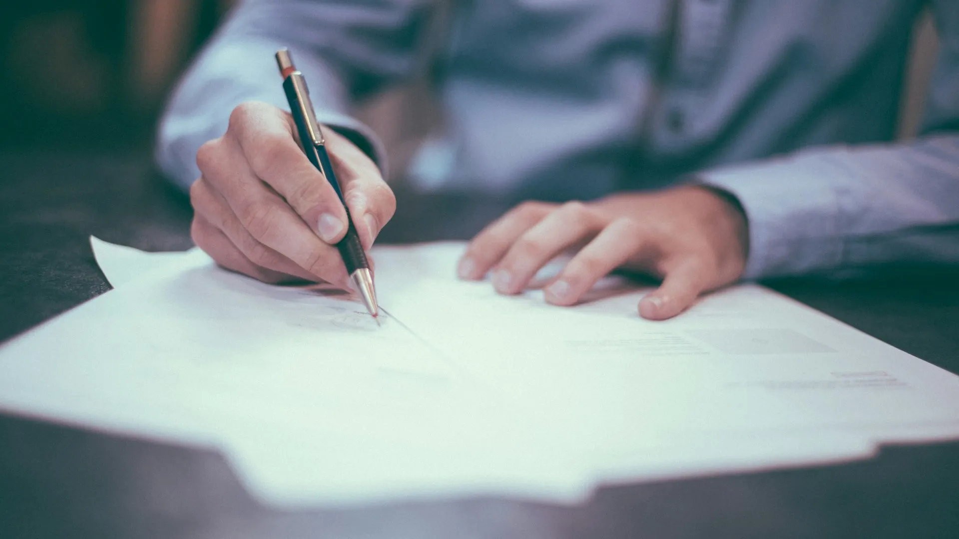 Person reviewing pain and suffering settlement paperwork with medical documents